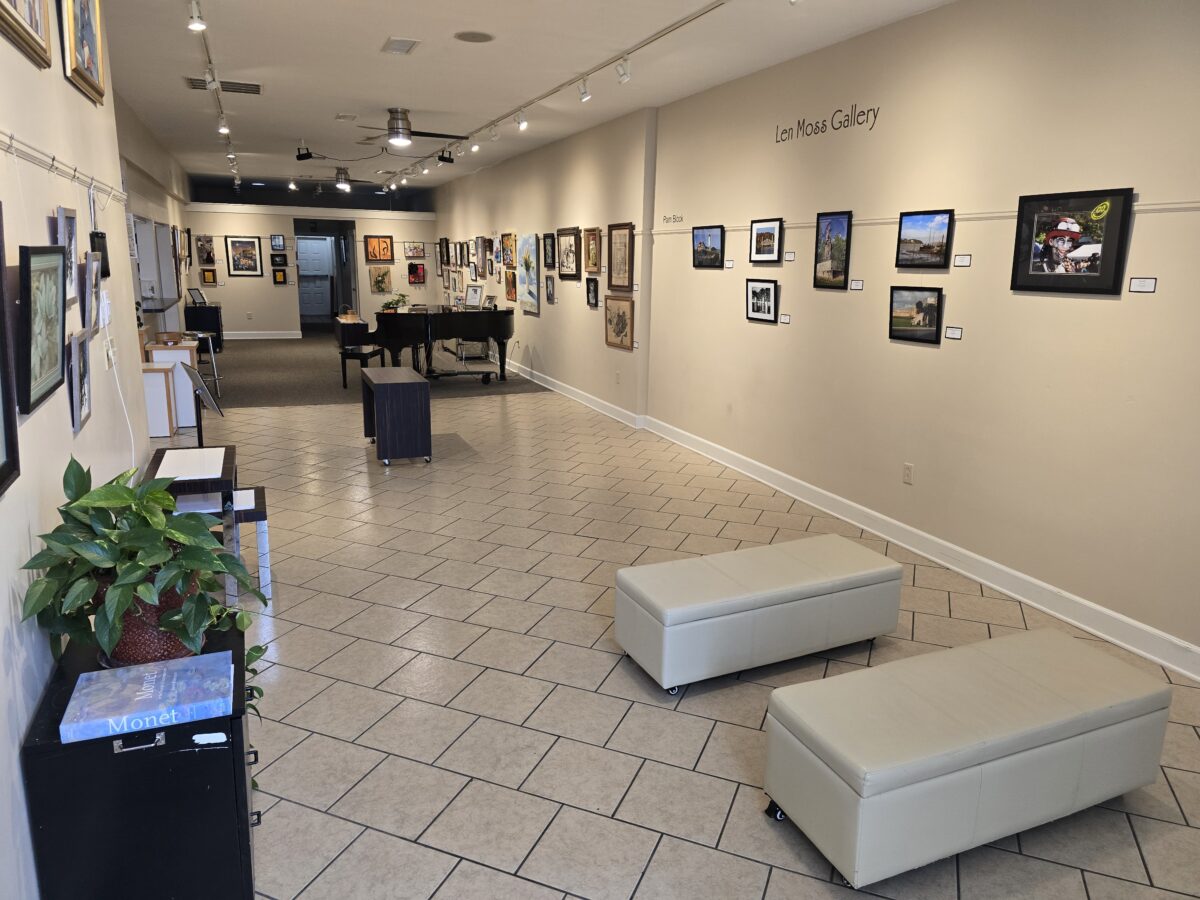 The interior of an arts building, with seating and art along the walls.