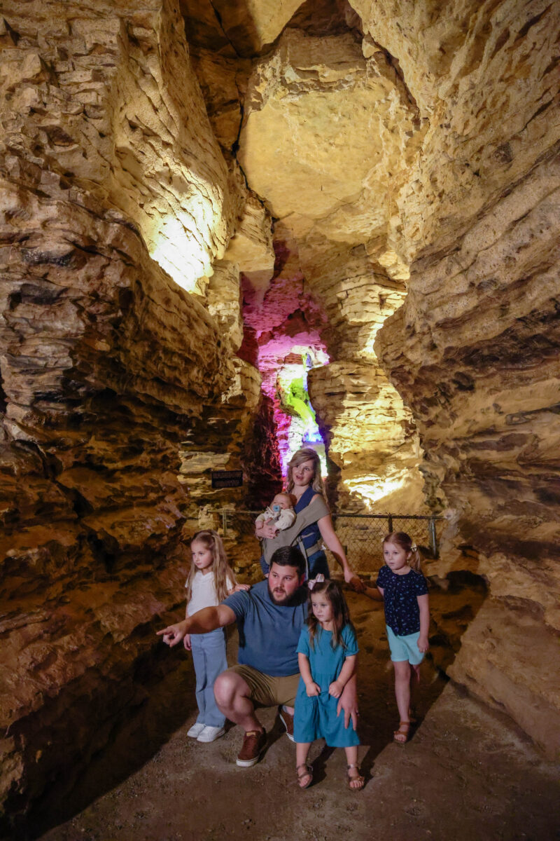 Several people posed for a photo inside a cave.