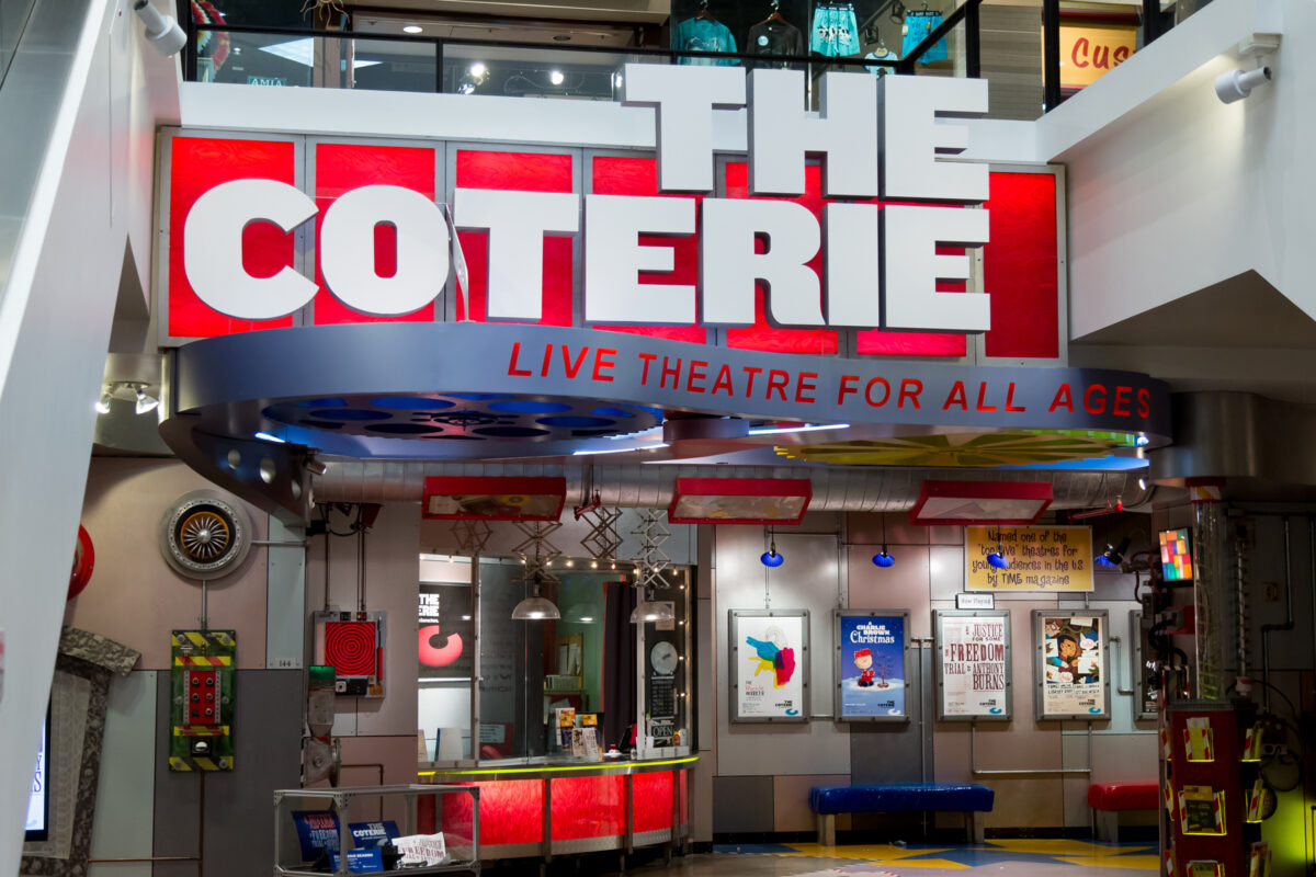 The lobby of a live performance theater, with bright colors and lights.