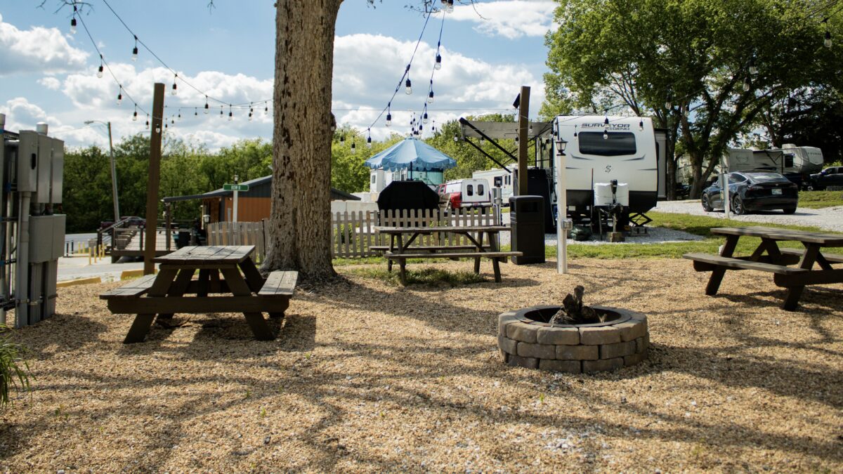 A camping area, with picnic table and fire pit.