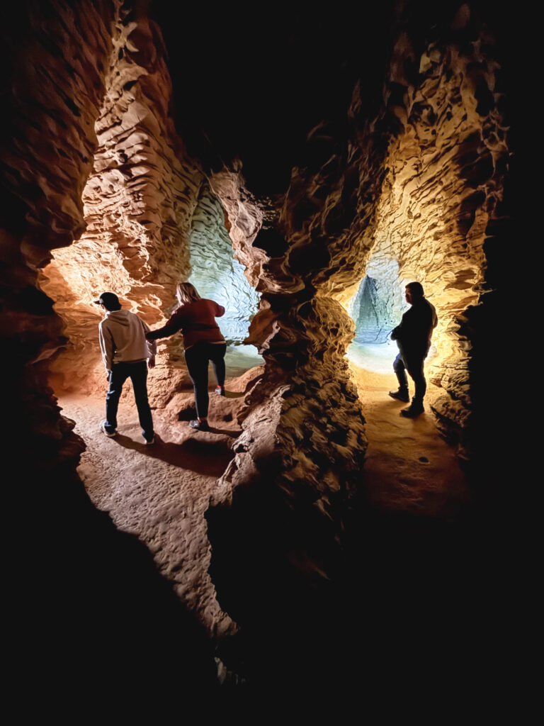 People inside a cave with two passages.