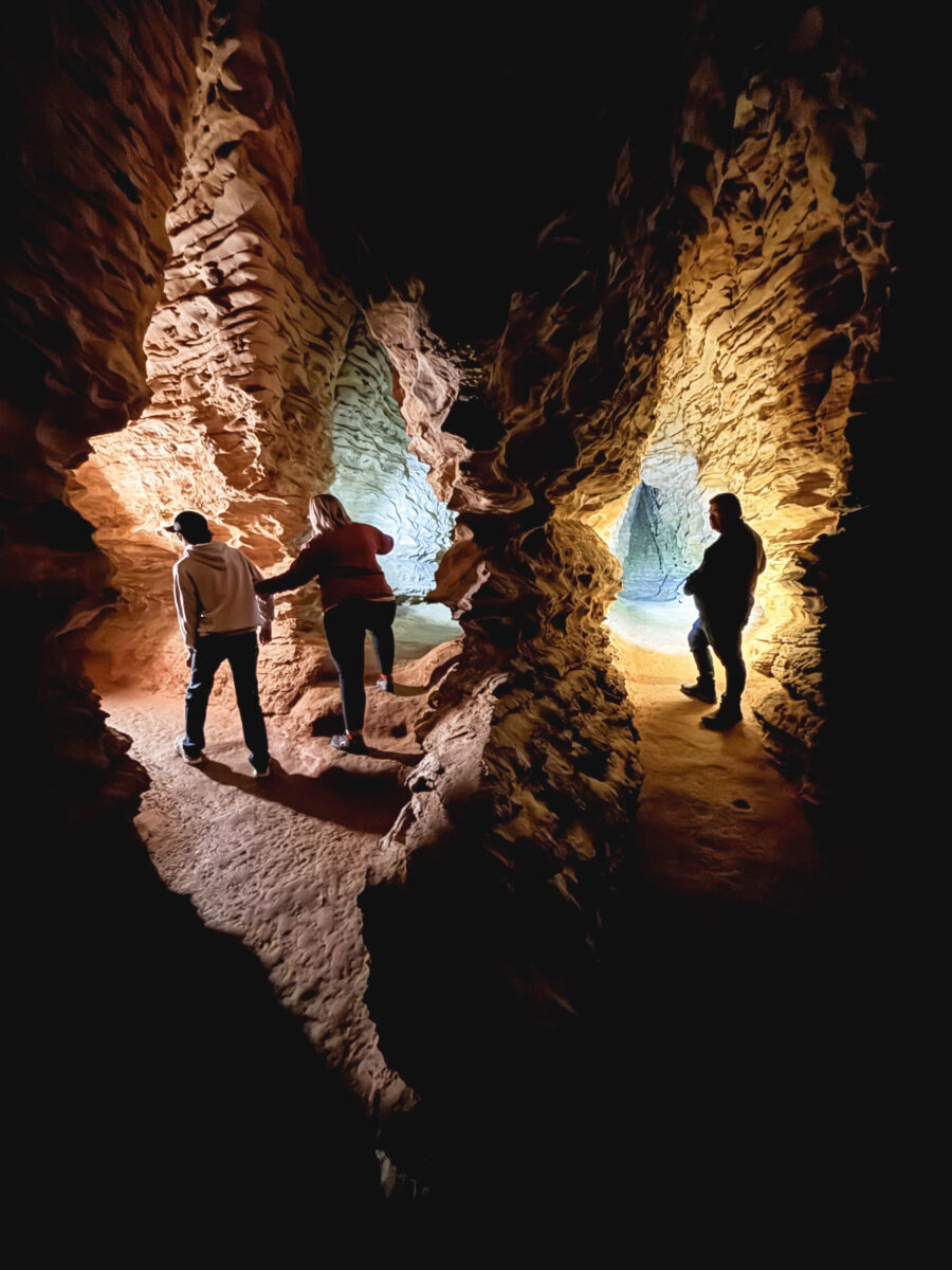 People inside a cave with two passages.