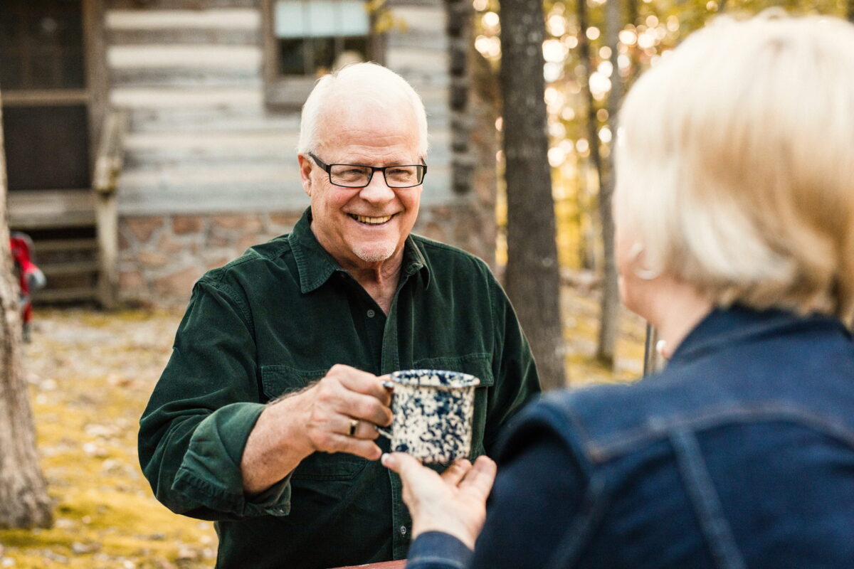 A couple enjoys a cup of coffee at the Silver Dollar City Campground.