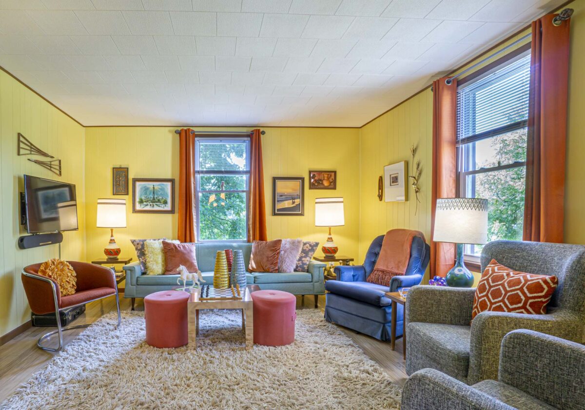 A colorful retro living room, with vintage-style furniture and lighting.