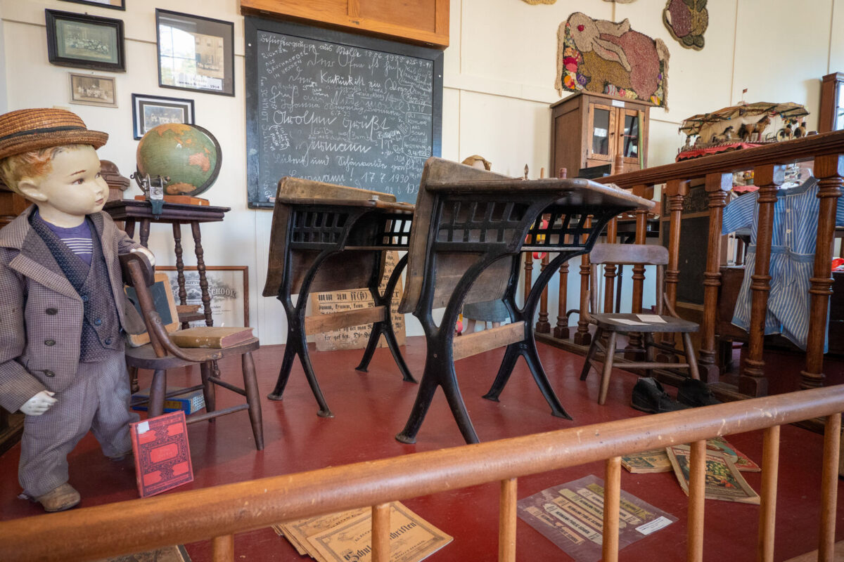 Wooden desks as part of a museum display.