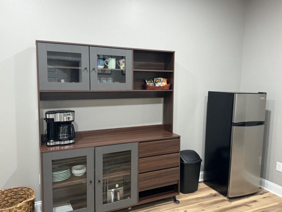 Hutch with coffee maker, air fryer, plates, utensils, mini fridge etc.
