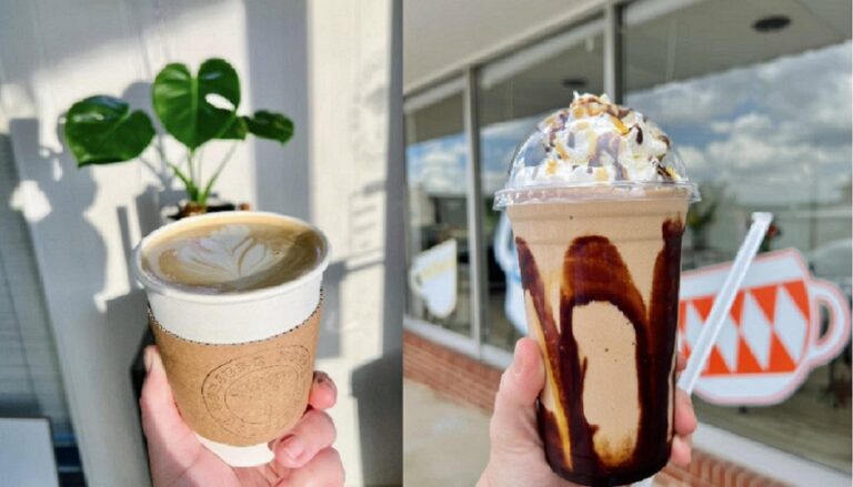 Two cups of coffee held up near a shop.