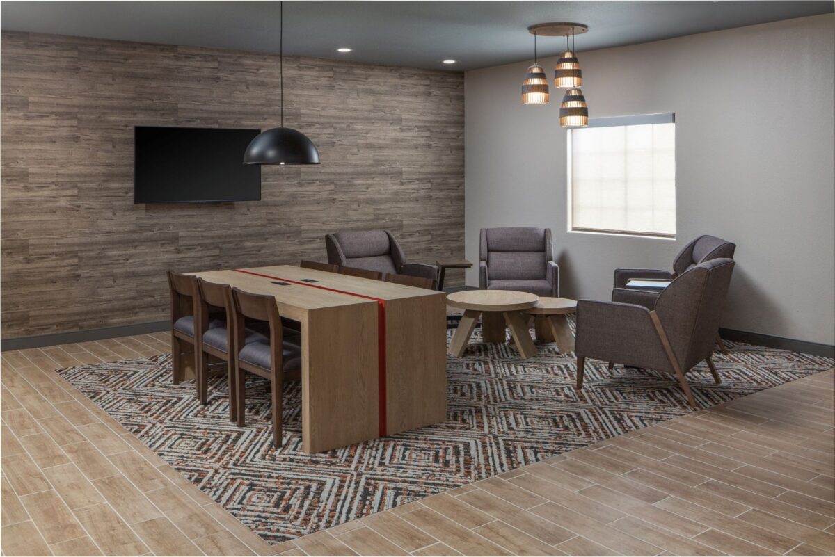 Lobby area with seating and a table for work or gathering.