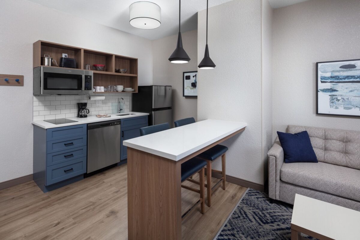 One bedroom suite kitchen area with bar separating the living room area.