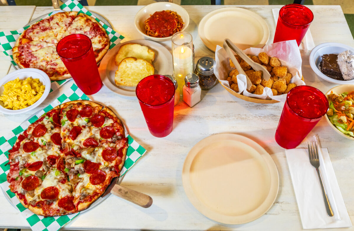 A spread of food including pizzas, sides, salads and drinks at Pagliai's Pizza.
