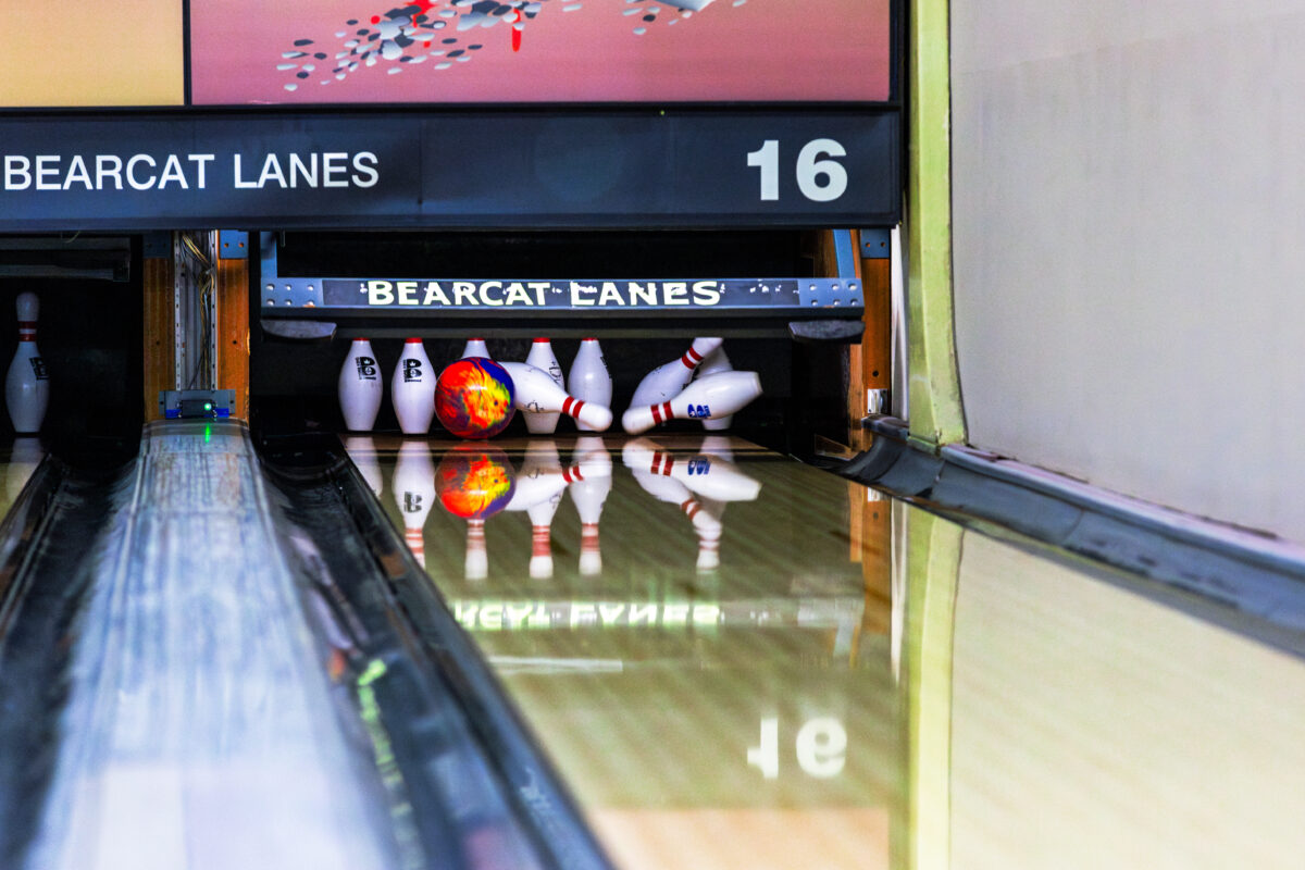 An orange bowling ball strikes pins at Bearcat Lanes and Lounge in Maryville.