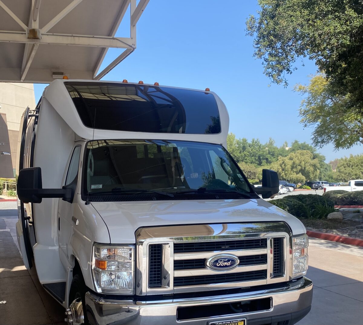 A white camper outside on a sunny day.
