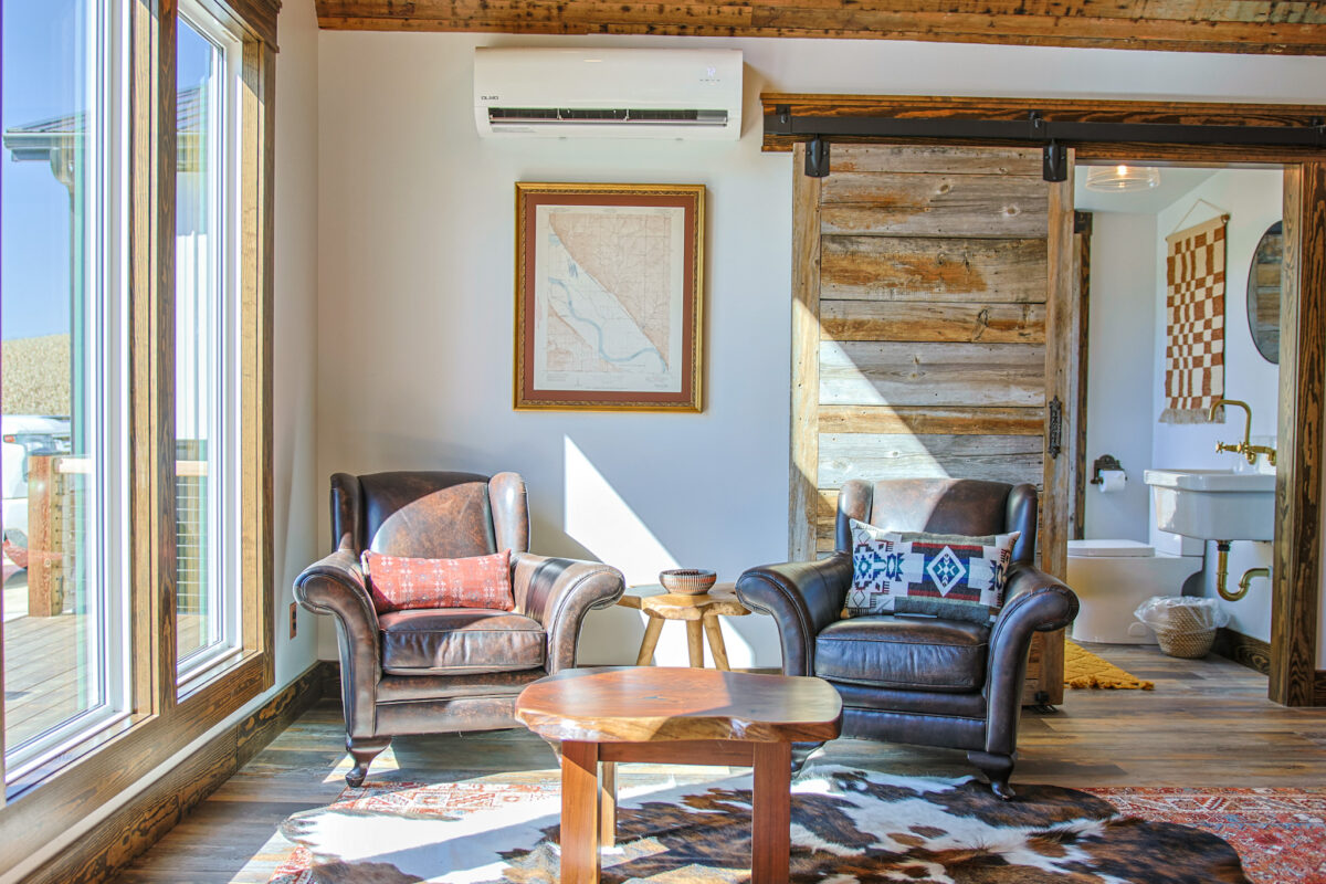 living area-two chairs-table-natural sunlight-animal rug