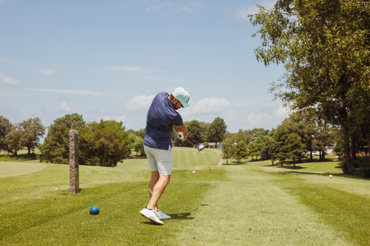A golfer swings at a ball at Hidden Trails Country Club.