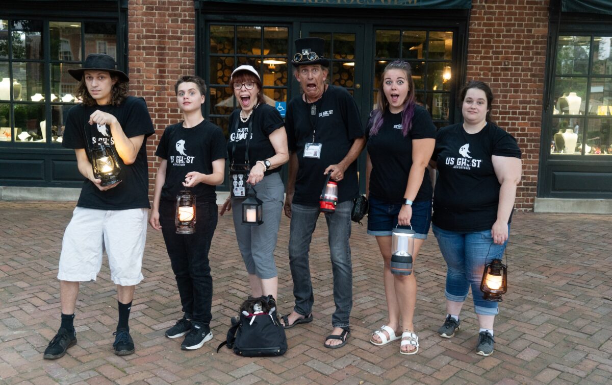 Six people with lanterns pose in Branson.