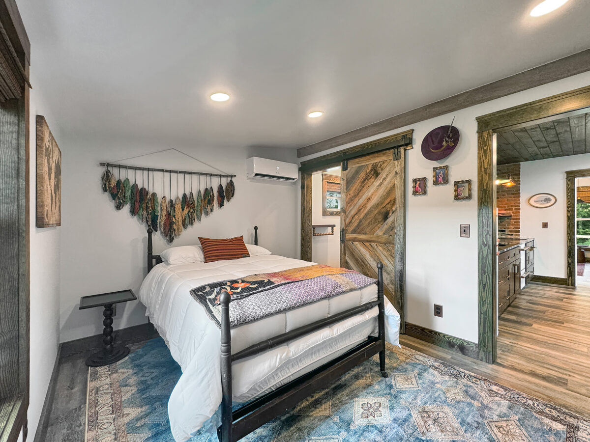 bedroom-featuring-full size bed-colorful decorations-bathroom