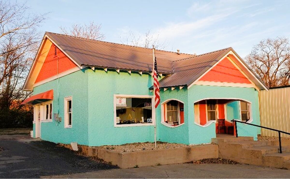 The exterior of a teal and orange building.
