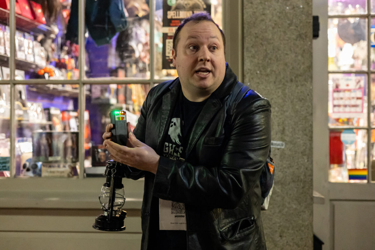 A man stands with an Electromagnetic Fields monitor.
