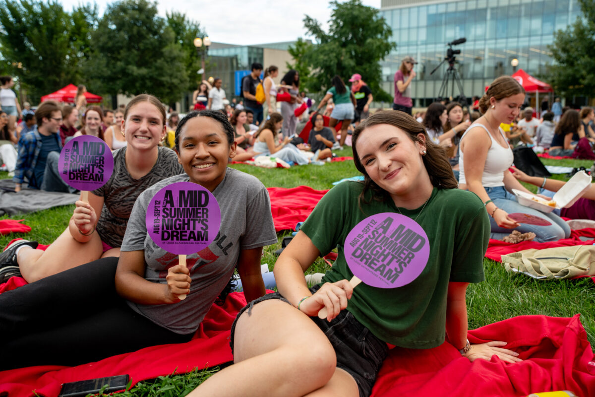 Attendees enjoy an outdoor Shakespeare event.
