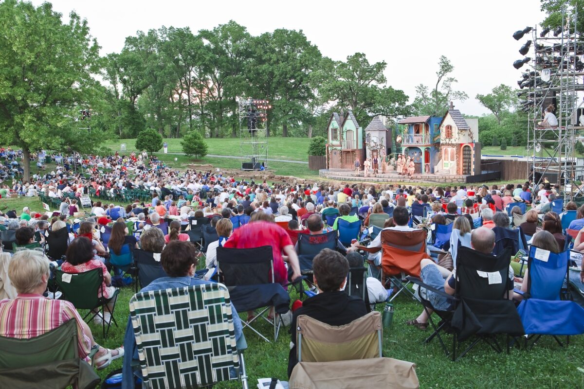 Attendees enjoy an outdoor Shakespeare event.