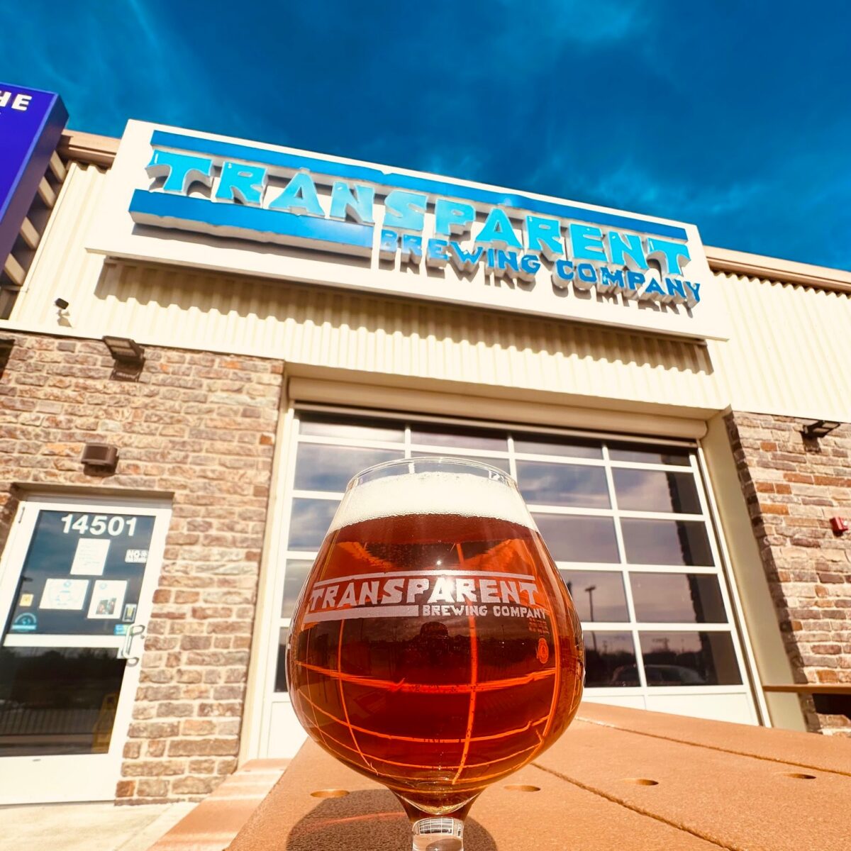 Glass of Beer on a picnic table at the Transparent Brewing Co. patio.