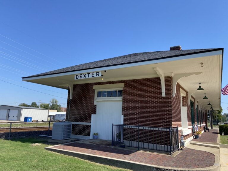 The outside of a brown and white building.