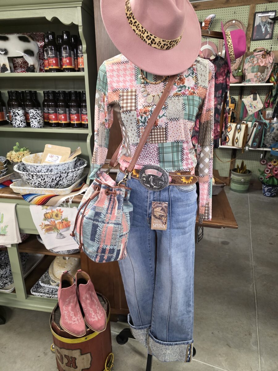 A pink and denim outfit styled on a mannequin with a pair of pink shoes next to it.