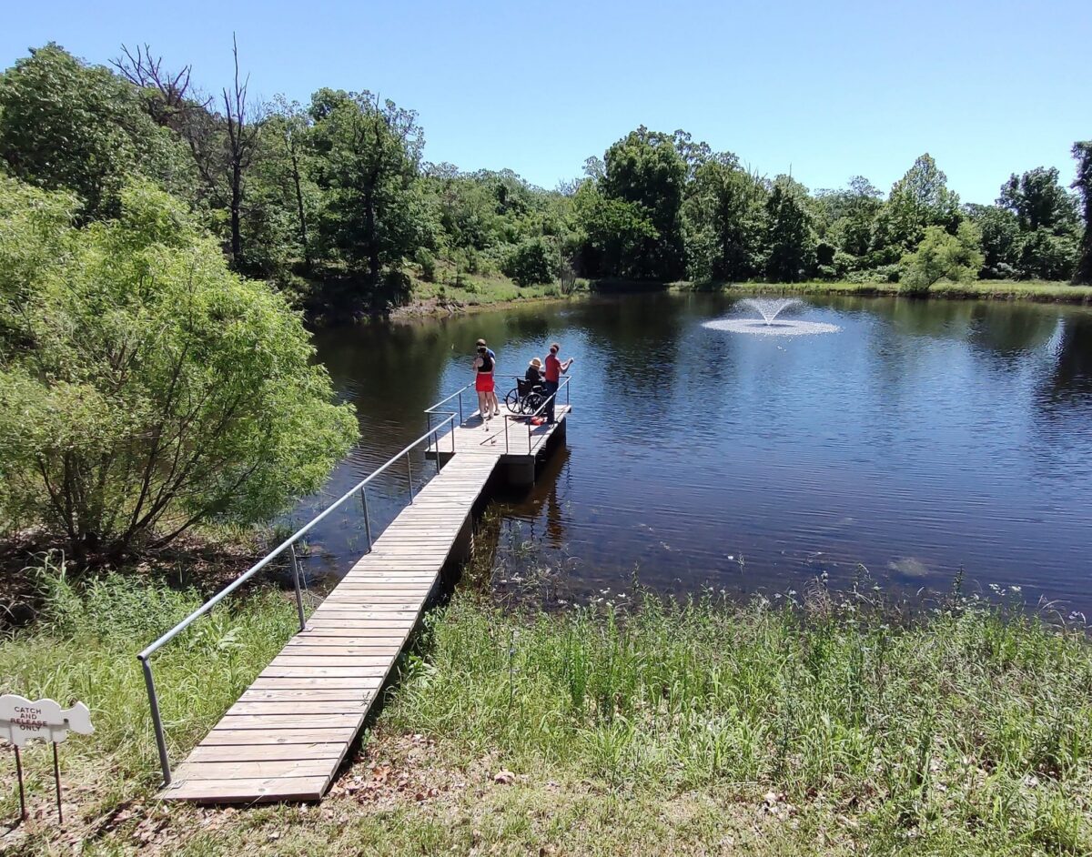 People on a dock in blue water.