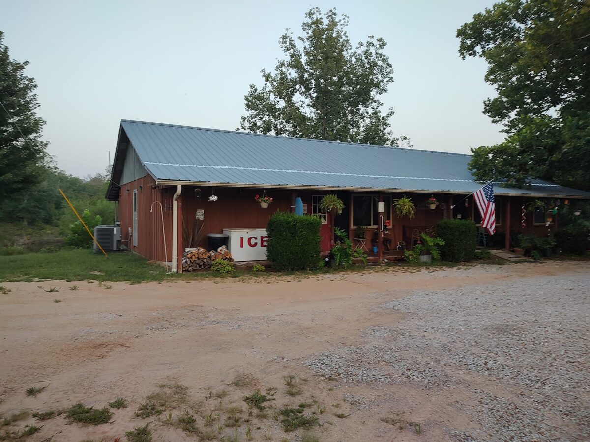 The exterior of a cabin with red walls.