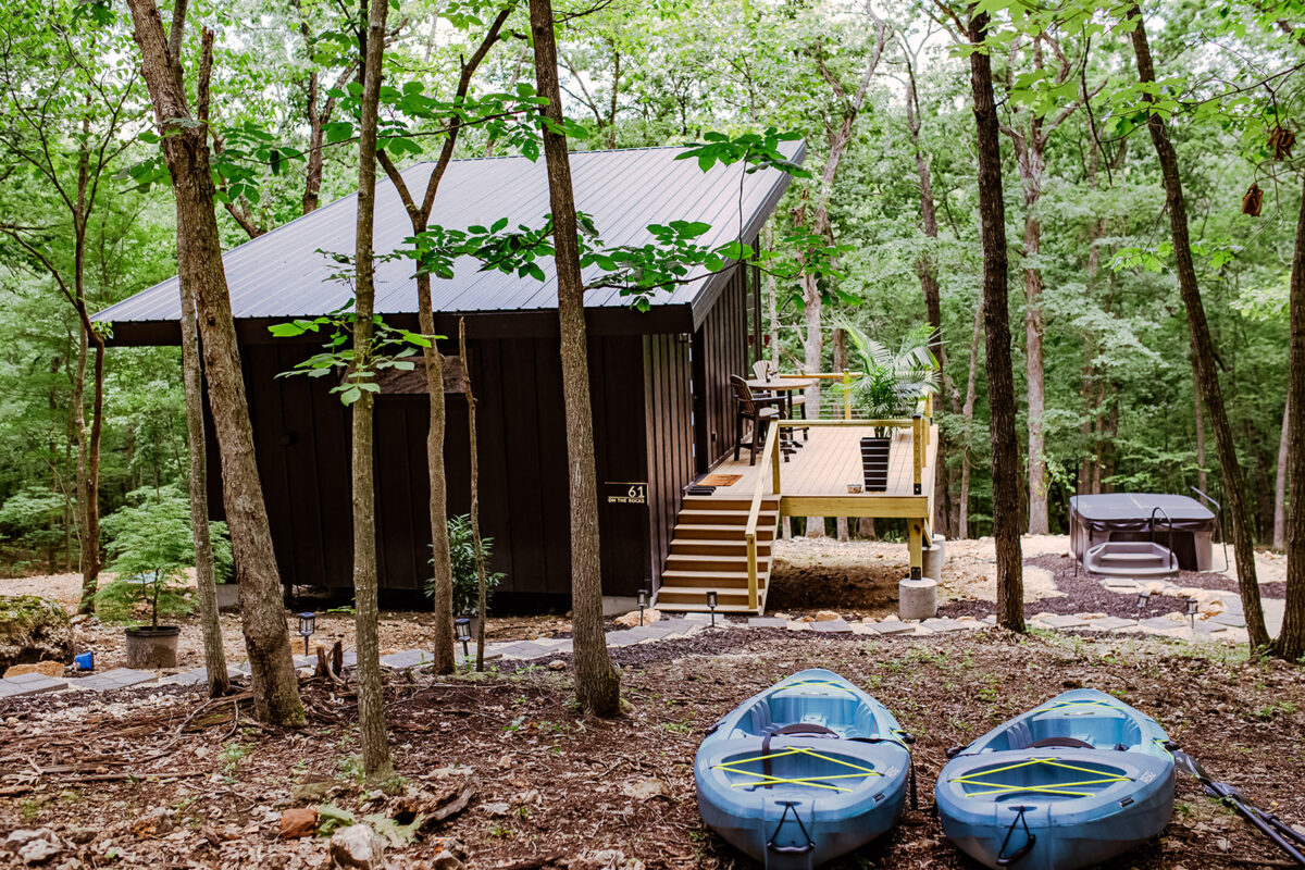 Two boats outside of a cabin.