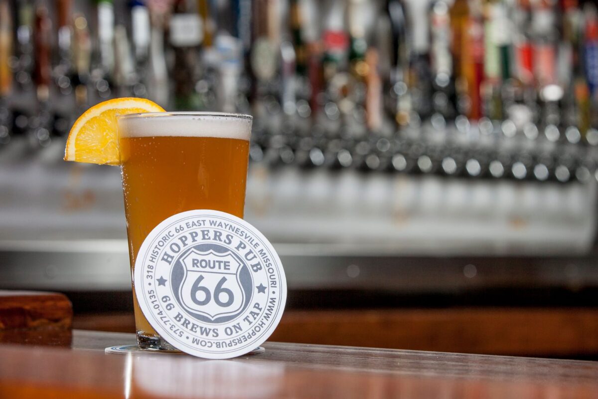 A glass of beer and a Route 66 coaster.