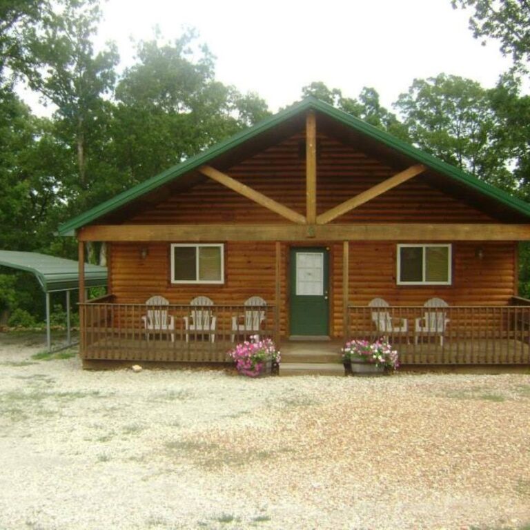 A brown cabin with a green roof.