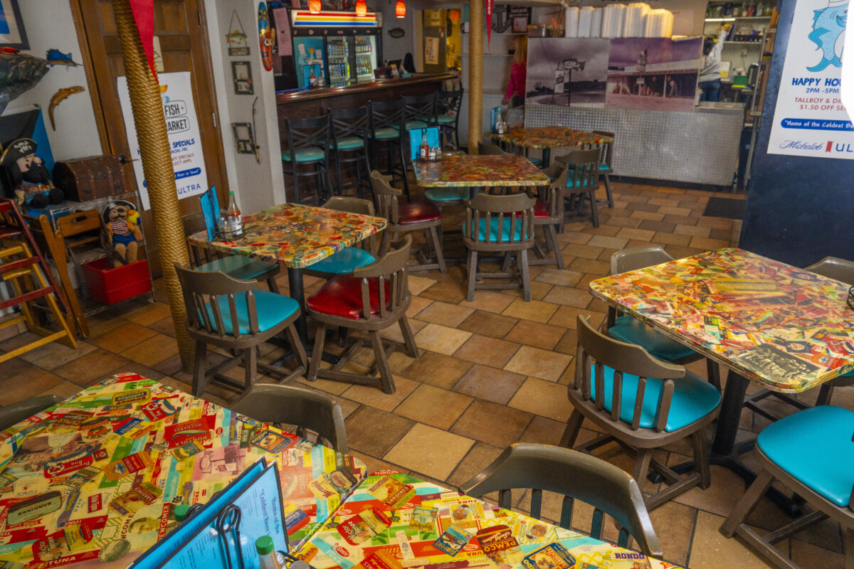 Interior dining area with colorful tables and coastal decorations at The Fish Market