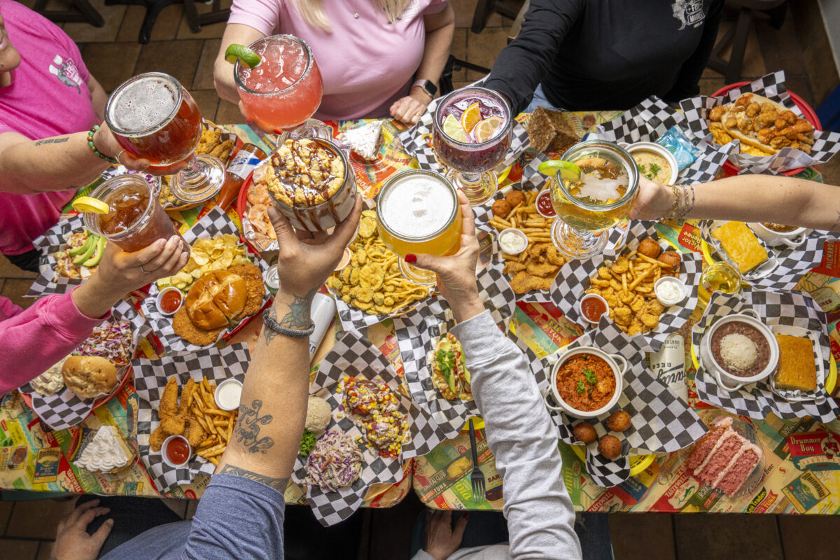 Friends enjoying seafood, drinks, and appetizers together at The Fish Market restaurant