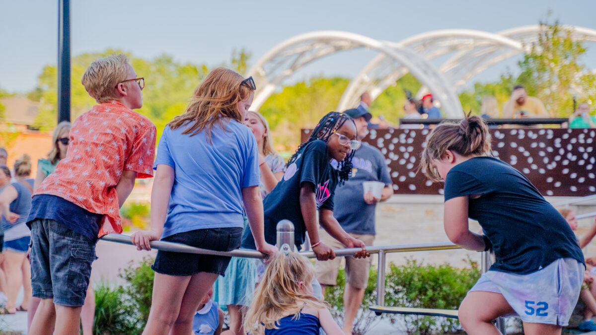 Children play outdoors during a farmers market event.