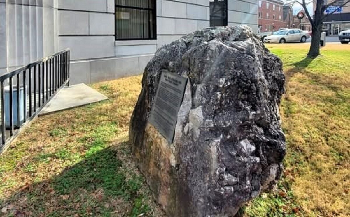 A large rock with a placard commemorating a battle.