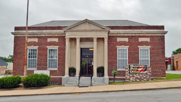 Exterior of a historic brick building with columns.