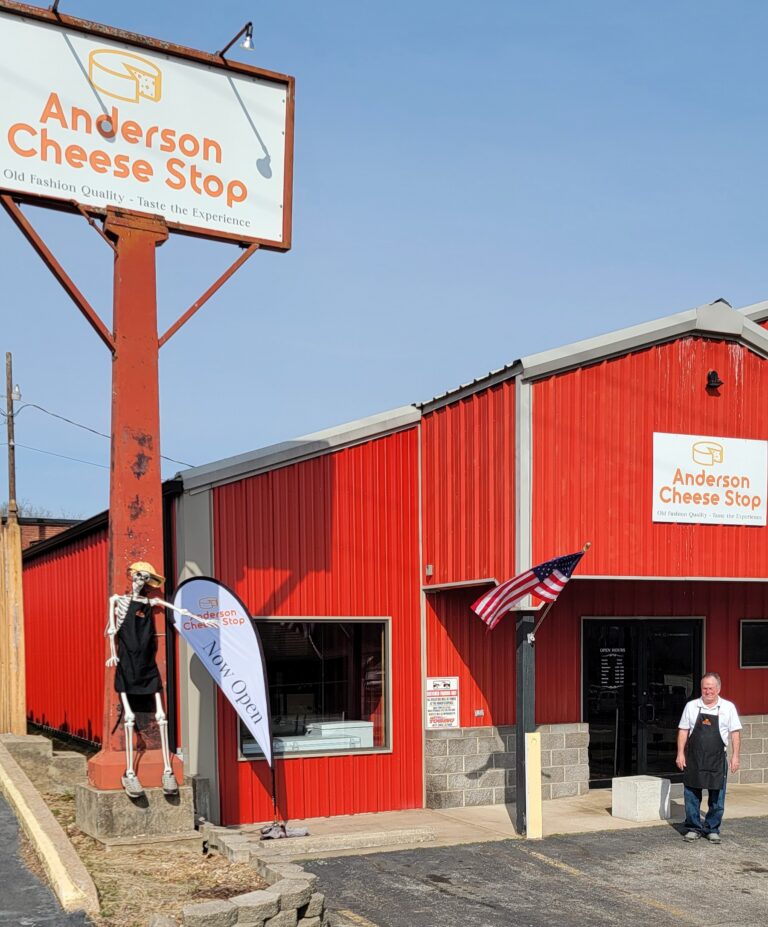 The outside of a red building labeled the Anderson Cheese Stop
