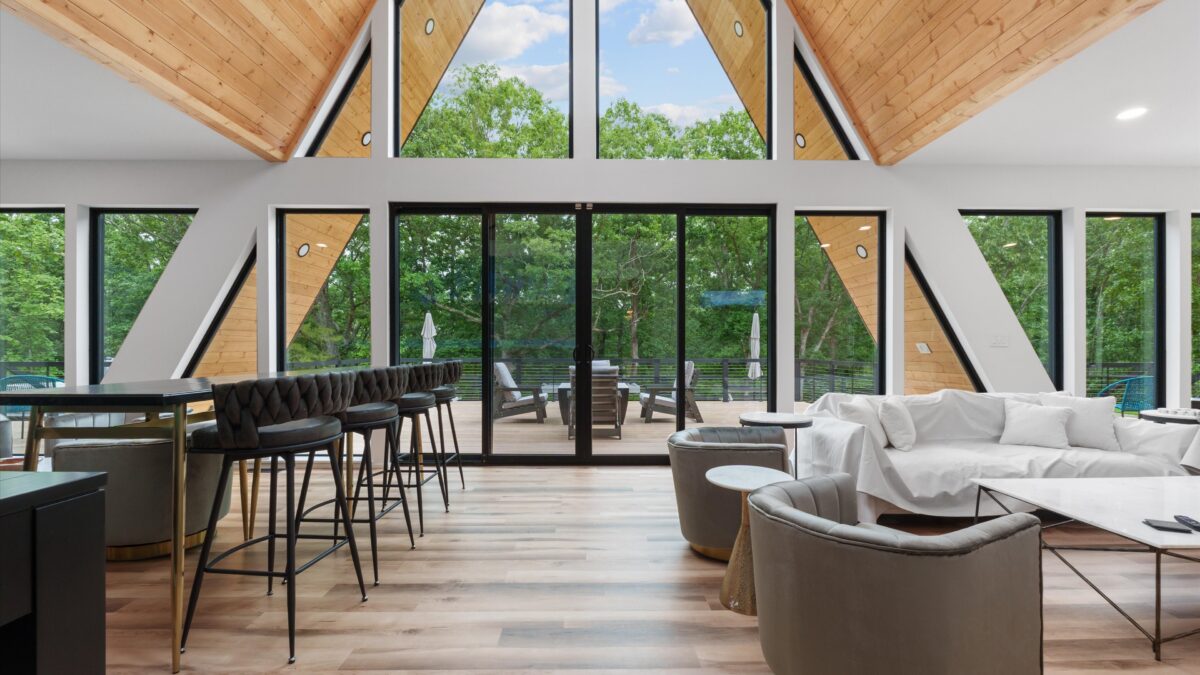 Luxury A-frame living room with floor-to-ceiling windows near Hermann Missouri