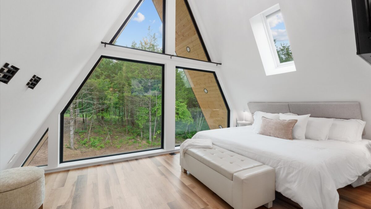 Modern bedroom with large windows at a luxury Hermann, Missouri vacation rental