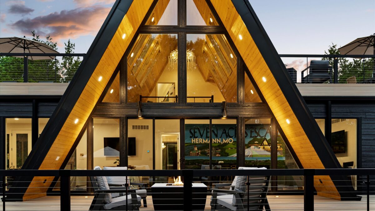 Luxury A-frame interior with warm lighting and vaulted ceilings