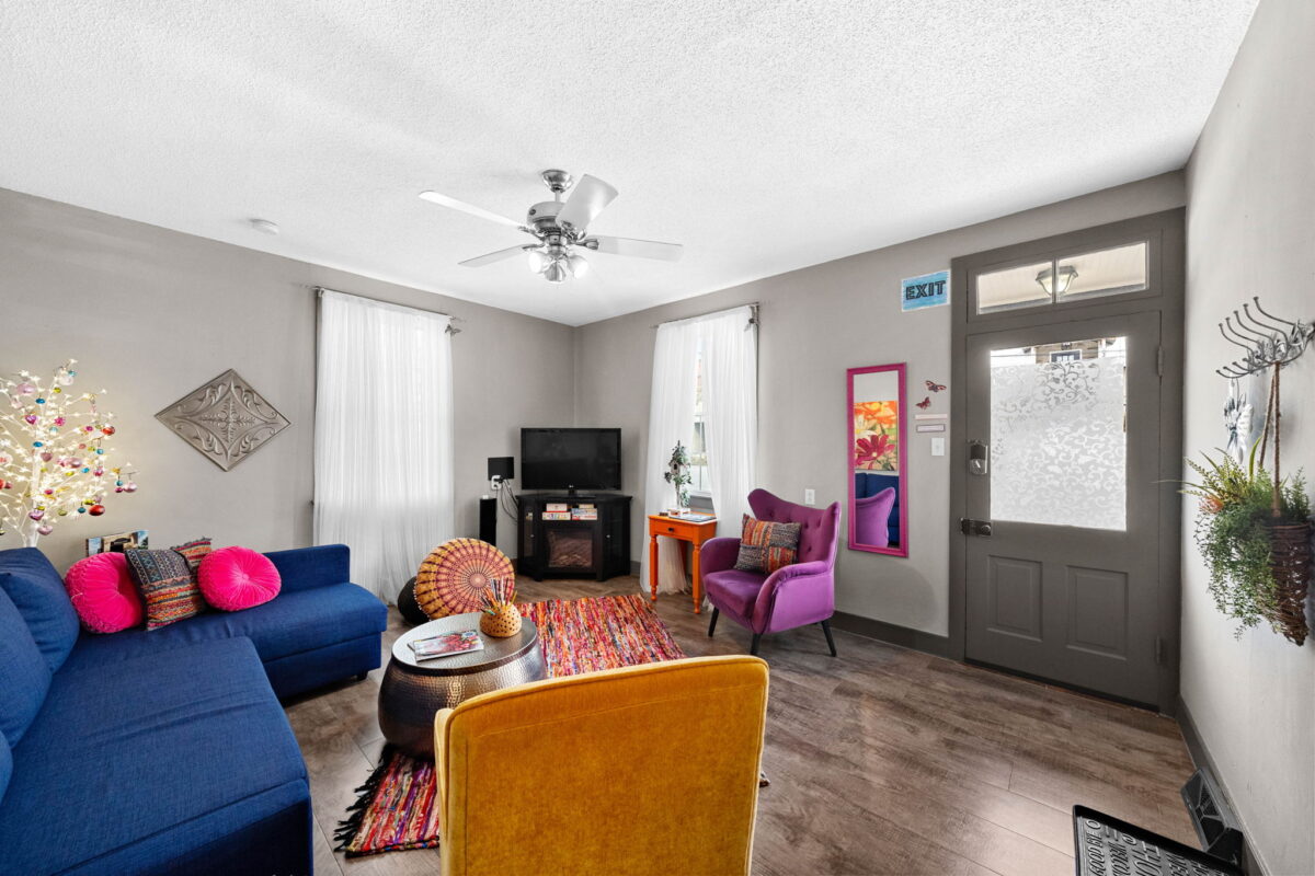 A furnished living room with couches and chairs.