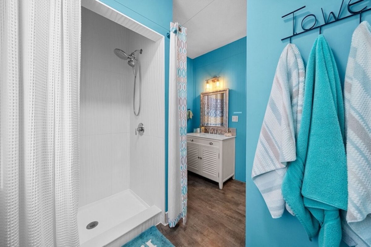 The interior of a bathroom with towels and a vanity.