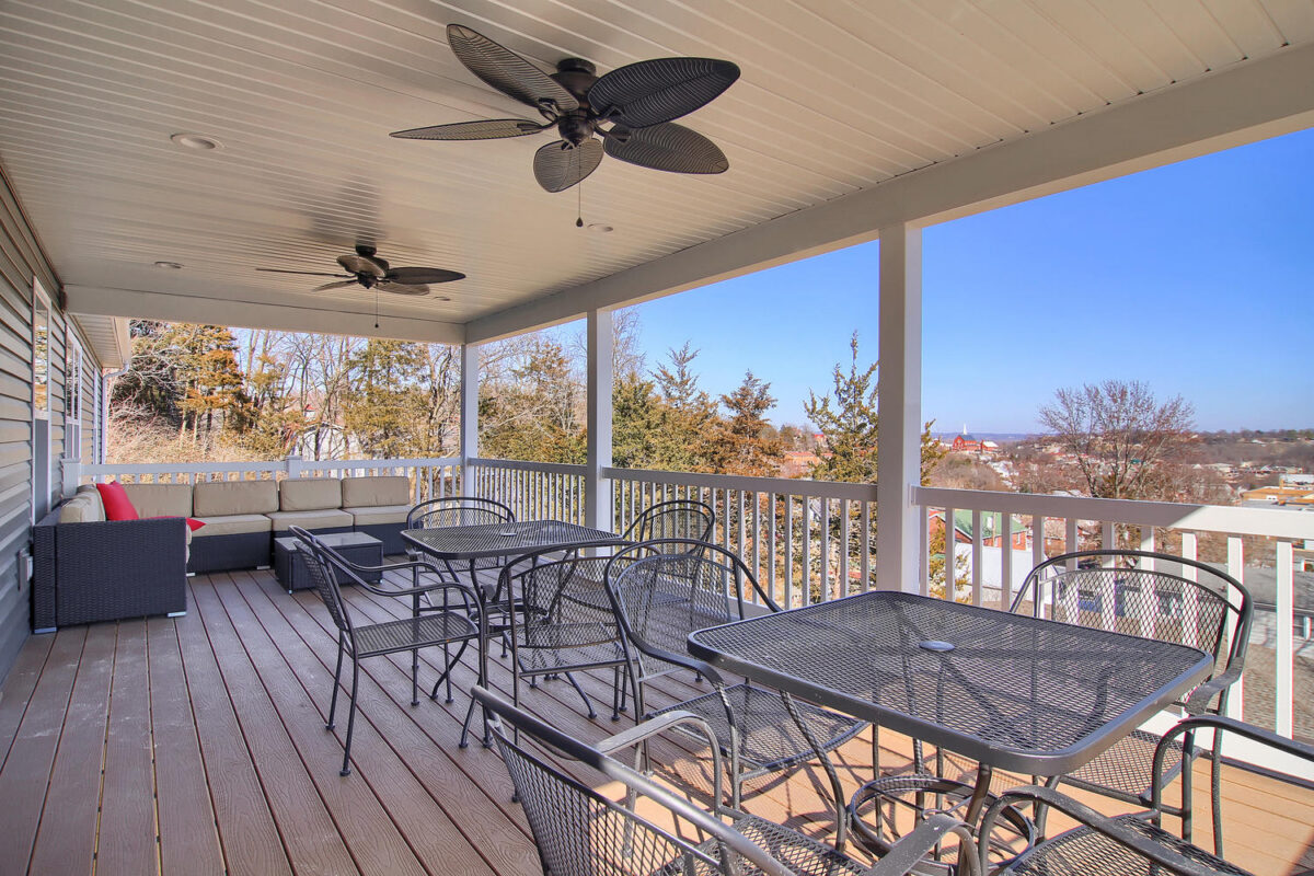 A patio with tables, chairs and other head fans.