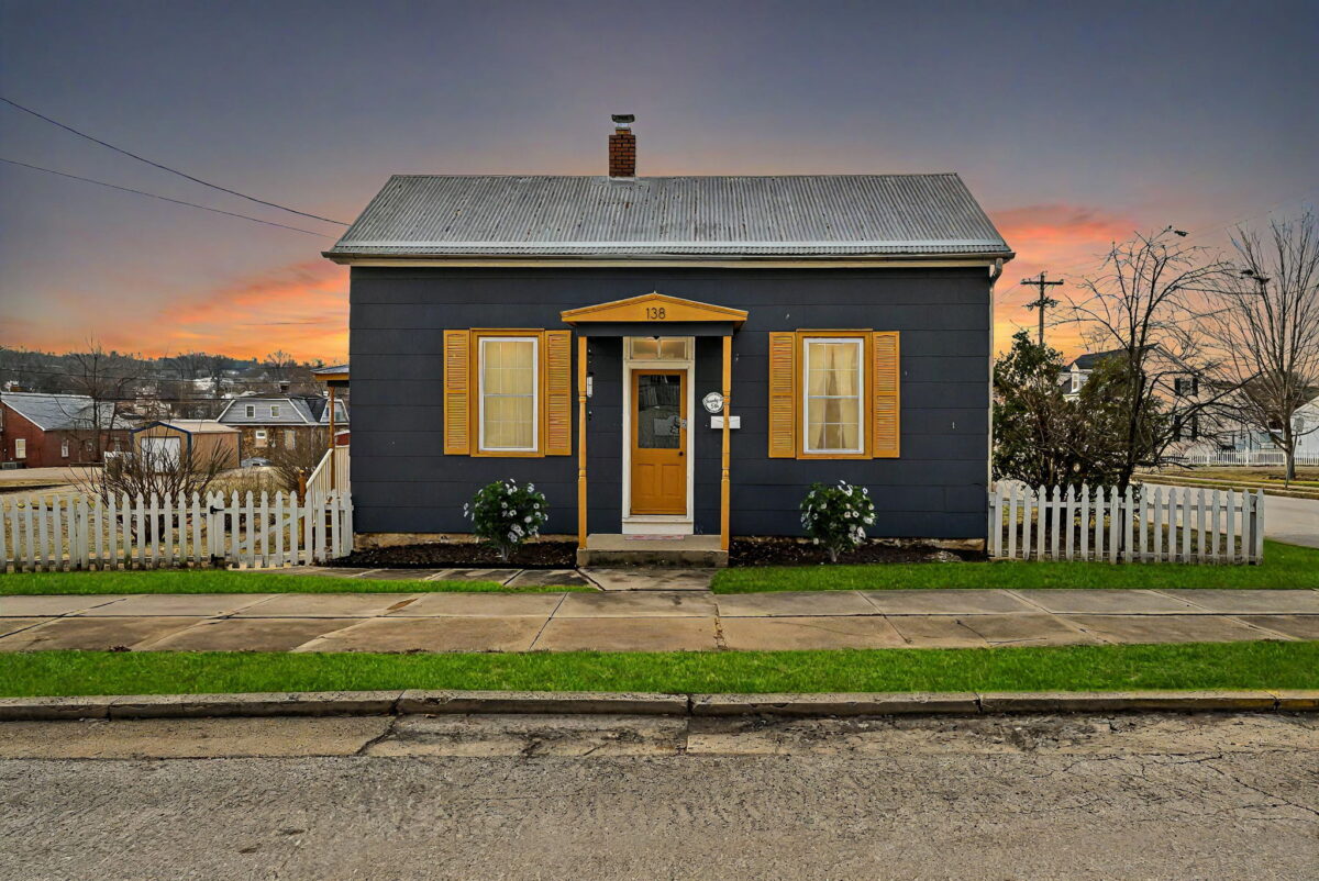 The outside of a cabin in front of a colorful skyline.