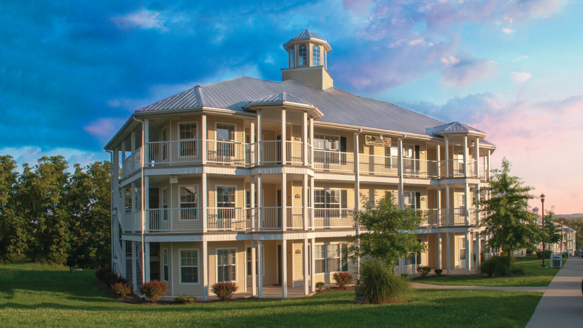 Exterior of a hotel against a colorful sky.