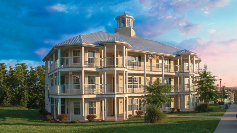 Exterior of a hotel against a colorful sky.