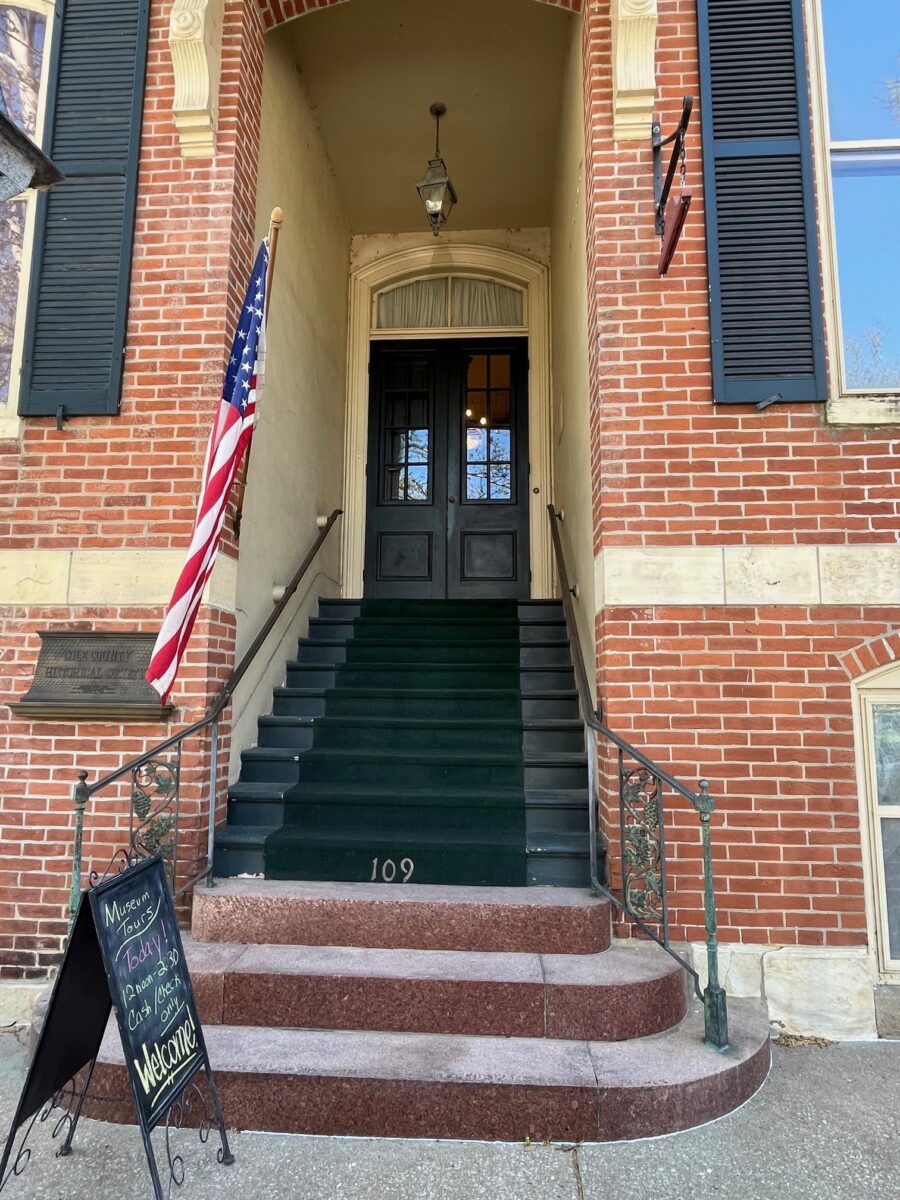 Steps up to a brick museum building.