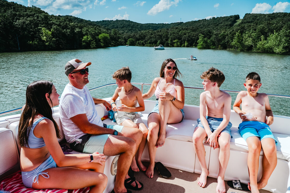 Several people lounge atop a houseboat.