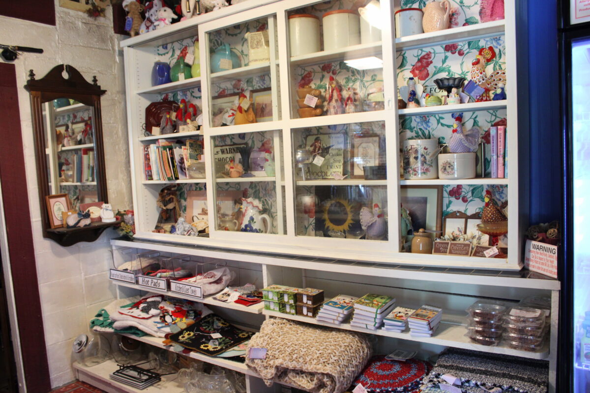 A shelf packed with items of many shapes, sizes and colors.